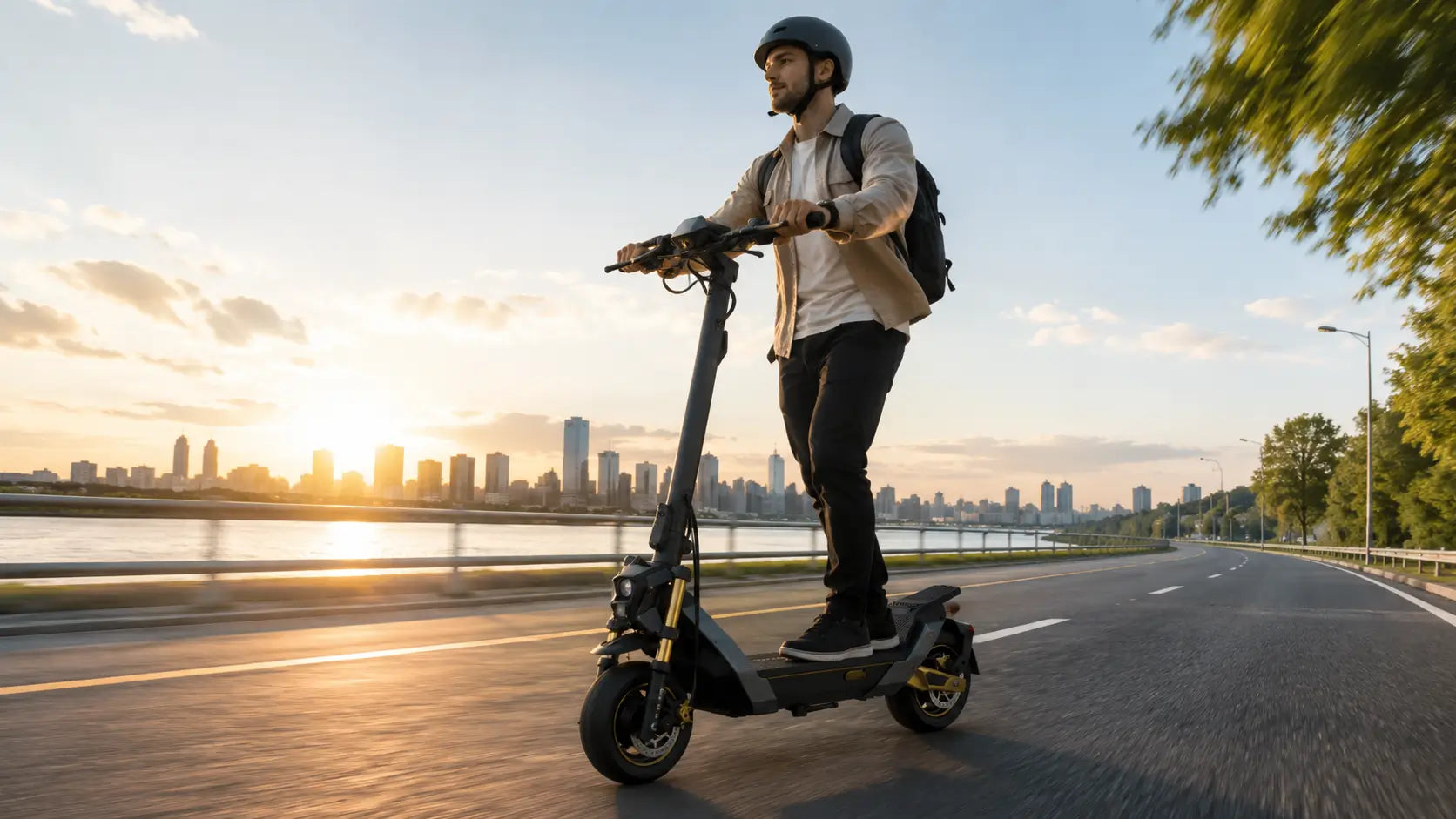 Rider commuting on a long-range electric scooter at sunrise.