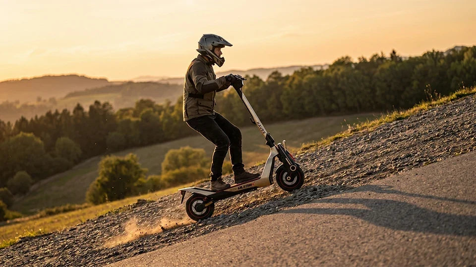 Experienced rider climbing a steep gravel hill on a NAVEE UT5 Ultra X all-terrain electric scooter