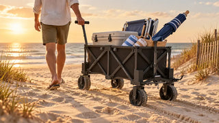 Electric beach wagon carrying chairs, towels, a cooler, and an umbrella across soft sand.